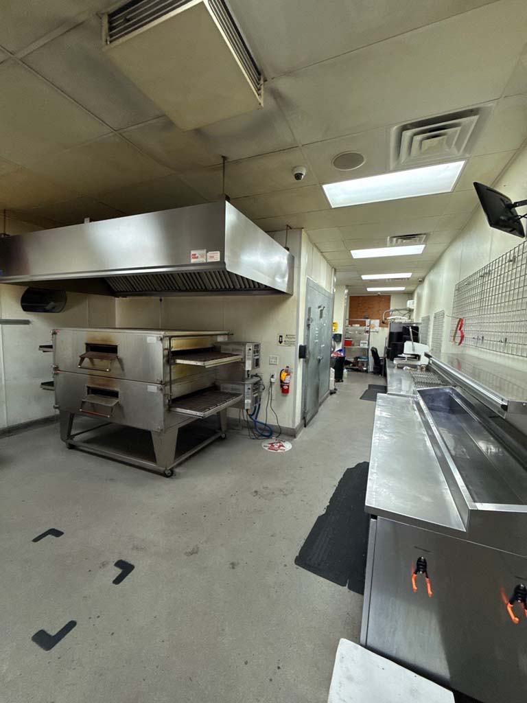 Pizzeria equipment liquidation sale featuring ovens and warmers