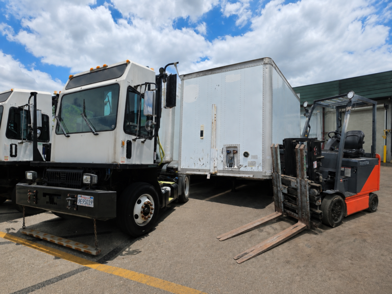 Industrial yard with truck and forklift